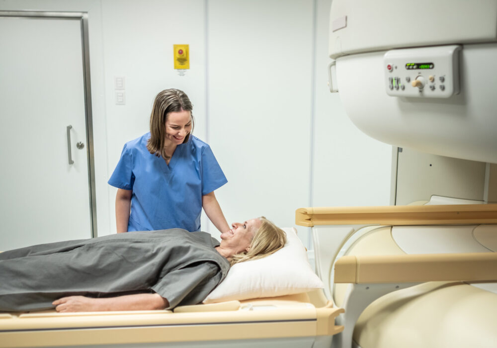 Female radiology student speaks with patient